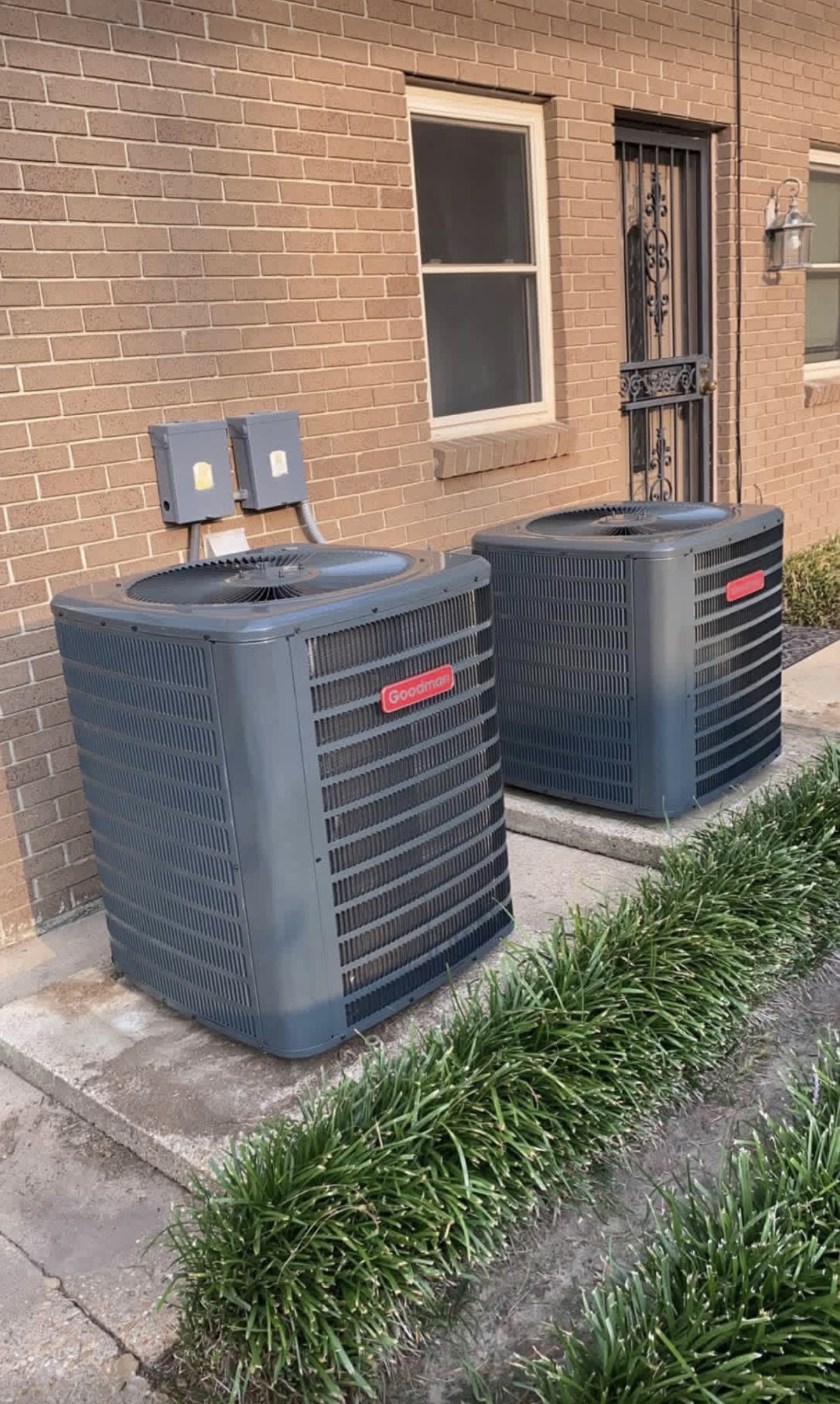 Two outdoor air conditioning units at a home
