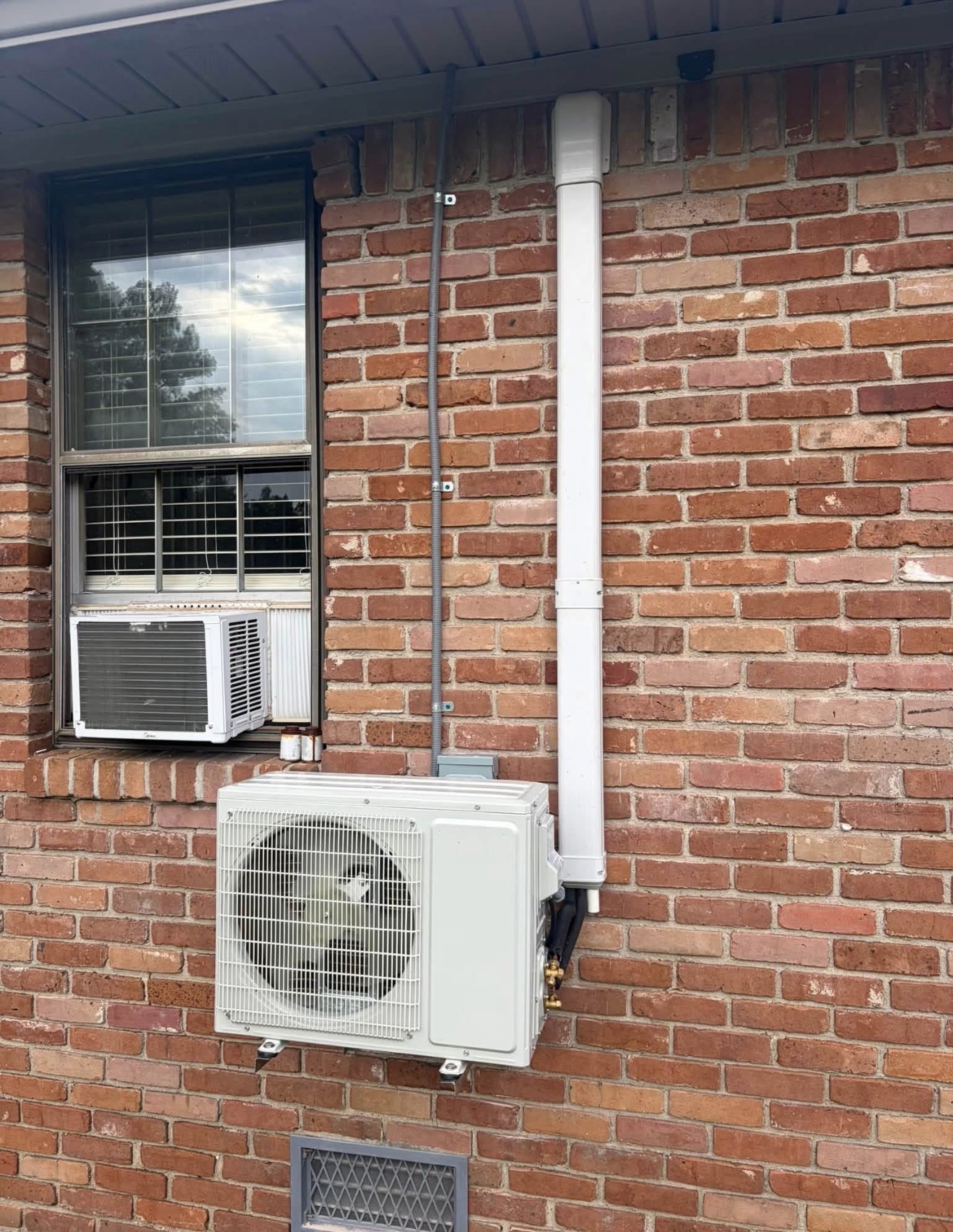 Mini split system installed on a brick home